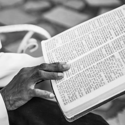Jamaican reading an open Bible